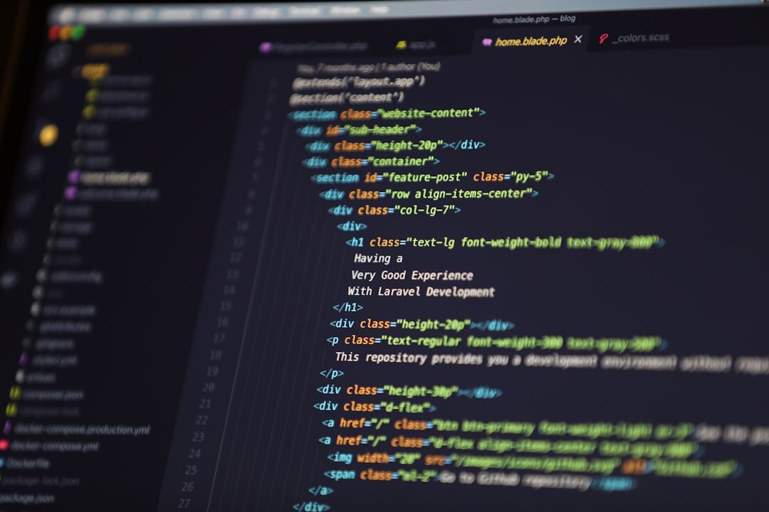 Software developer writing code on multiple monitors with colorful syntax highlighting