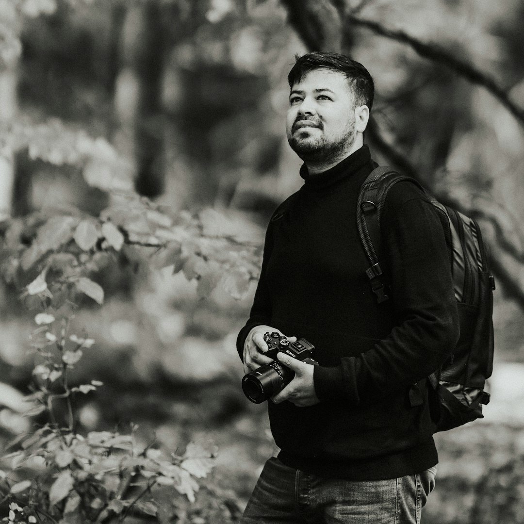 Professional Turkish male journalist editor in business attire smiling at camera
